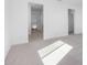 Bright hallway with carpet and doors to bedrooms and closets at 17975 W Vogel Ave, Goodyear, AZ 85338