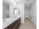 Modern bathroom with double vanity and dark brown cabinets at 17975 W Vogel Ave, Goodyear, AZ 85338