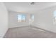 Well-lit bedroom featuring a large window and carpeted floor at 17975 W Vogel Ave, Goodyear, AZ 85338