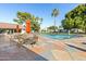 Community pool with patio furniture and umbrellas at 201 S Greenfield Rd # 11, Mesa, AZ 85206