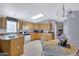 Galley kitchen with wood cabinets, island, and dining area at 201 S Greenfield Rd # 11, Mesa, AZ 85206