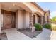 Detailed view of the front entry with stone columns and a decorative door at 6918 E Granada St, Mesa, AZ 85207