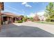 House exterior showcasing stone accents, gated entry, and a large driveway at 6918 E Granada St, Mesa, AZ 85207