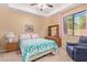 Bedroom with teal bedding and a comfortable armchair at 6918 E Granada St, Mesa, AZ 85207