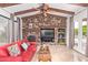 Gathering room features a stone fireplace, large TV, and access to backyard at 6918 E Granada St, Mesa, AZ 85207