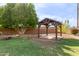 Wooden gazebo nestled in a lush green backyard at 6918 E Granada St, Mesa, AZ 85207
