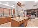Open kitchen with an island, wood cabinets, and views into the living room at 6918 E Granada St, Mesa, AZ 85207