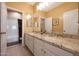 Bathroom with granite countertop double vanity and tub at 14867 W Windsor Ave, Goodyear, AZ 85395