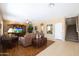 Living room with hardwood floors, a large TV, and comfortable seating at 14867 W Windsor Ave, Goodyear, AZ 85395