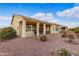 Covered patio, grassy area, and desert landscaping at 42818 W Morning Dove Ln, Maricopa, AZ 85138