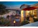 Inviting backyard patio with fire pit, seating area, and umbrella at 42818 W Morning Dove Ln, Maricopa, AZ 85138