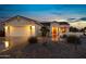 Attractive single-story home with a two-car garage and well-manicured landscaping at 42818 W Morning Dove Ln, Maricopa, AZ 85138