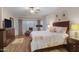 Main bedroom with a king-size bed and plenty of natural light at 42818 W Morning Dove Ln, Maricopa, AZ 85138