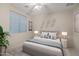 Bedroom with a large bed, two nightstands, and neutral decor at 42818 W Morning Dove Ln, Maricopa, AZ 85138