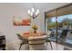 Bright dining area with glass table and chairs, adjacent to patio at 42818 W Morning Dove Ln, Maricopa, AZ 85138