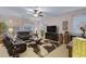 Spacious living room with leather furniture and large TV at 42818 W Morning Dove Ln, Maricopa, AZ 85138