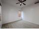 Well-lit bedroom with ceiling fan and carpet flooring at 8207 W Florence Ave, Phoenix, AZ 85043