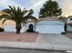 White house with a two-car garage and palm tree at 1563 S Pennington Dr, Chandler, AZ 85286