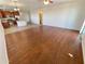 Open concept living room with hardwood floors and kitchen view at 12059 W Carlota Ln, Sun City, AZ 85373