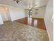 Open living room with hardwood and tile flooring at 12059 W Carlota Ln, Sun City, AZ 85373