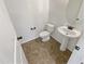 Clean bathroom with pedestal sink and tiled floor at 12059 W Carlota Ln, Sun City, AZ 85373