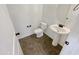 Clean bathroom with pedestal sink and tiled floor at 12059 W Carlota Ln, Sun City, AZ 85373
