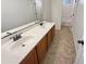 Guest bathroom with double vanity and neutral tile floors at 12059 W Carlota Ln, Sun City, AZ 85373