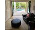 View of backyard pool through folding glass doors from living room with leather seating at 2468 S Salida Del Sol --, Chandler, AZ 85286