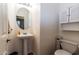 Clean and well-maintained half bathroom with pedestal sink and toilet at 16806 W Halifax St, Surprise, AZ 85374