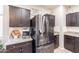 Modern kitchen with dark wood cabinets and granite countertops at 3816 N 298Th Ln, Buckeye, AZ 85396