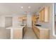 Modern kitchen with light wood cabinets and white countertops at 16683 W Saguaro Park Ln, Surprise, AZ 85387