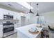 Modern kitchen with white cabinets, stainless steel appliances, and island at 22408 N Las Vegas Dr, Sun City West, AZ 85375