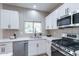 Stainless steel appliances and white cabinetry in a well-lit kitchen at 22408 N Las Vegas Dr, Sun City West, AZ 85375