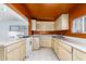 Kitchen with wood cabinets and tile floor at 515 W Romley Ave, Phoenix, AZ 85041