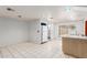Kitchen with white appliances and tile floor at 515 W Romley Ave, Phoenix, AZ 85041
