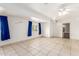 Spacious bedroom with tile flooring and blue curtains at 515 W Romley Ave, Phoenix, AZ 85041