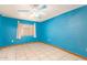 Blue bedroom with tile floors and ceiling fan at 515 W Romley Ave, Phoenix, AZ 85041