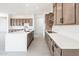 Open concept kitchen with wood cabinets and white counters at 115 E Santa Cruz Dr, Phoenix, AZ 85085
