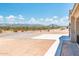 Side view of a house with desert landscape, mountain views, and a concrete patio at 115 E Santa Cruz Dr, Phoenix, AZ 85085
