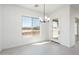 Bright dining area with chandelier and access to patio at 115 E Santa Cruz Dr, Phoenix, AZ 85085