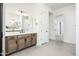 Bathroom with double vanity and access to hallway at 115 E Santa Cruz Dr, Phoenix, AZ 85085
