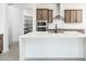Large kitchen island with white countertop and seating space at 115 E Santa Cruz Dr, Phoenix, AZ 85085