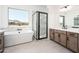 Luxurious bathroom with soaking tub, walk-in shower, and double vanity at 115 E Santa Cruz Dr, Phoenix, AZ 85085