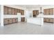 Bright kitchen with white quartz countertops and wood cabinets at 115 E Santa Cruz Dr, Phoenix, AZ 85085