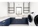 Bright laundry room with modern washer, dryer, and stylish cabinetry at 6836 N 13Th Pl # B, Phoenix, AZ 85014