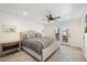 Spacious main bedroom with a king-size bed, striped bedding, and access to a patio at 7211 E Sunnyside Dr, Scottsdale, AZ 85260