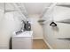 Laundry room with washer, dryer, and storage shelves at 7211 E Sunnyside Dr, Scottsdale, AZ 85260