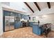 Updated kitchen featuring blue cabinetry, granite island, and terracotta flooring at 7211 E Sunnyside Dr, Scottsdale, AZ 85260