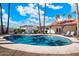 Relaxing kidney-shaped pool surrounded by a spacious patio and mature trees at 7211 E Sunnyside Dr, Scottsdale, AZ 85260