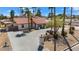 Single-story home with a red tile roof, paved driveway, and lush landscaping at 7211 E Sunnyside Dr, Scottsdale, AZ 85260